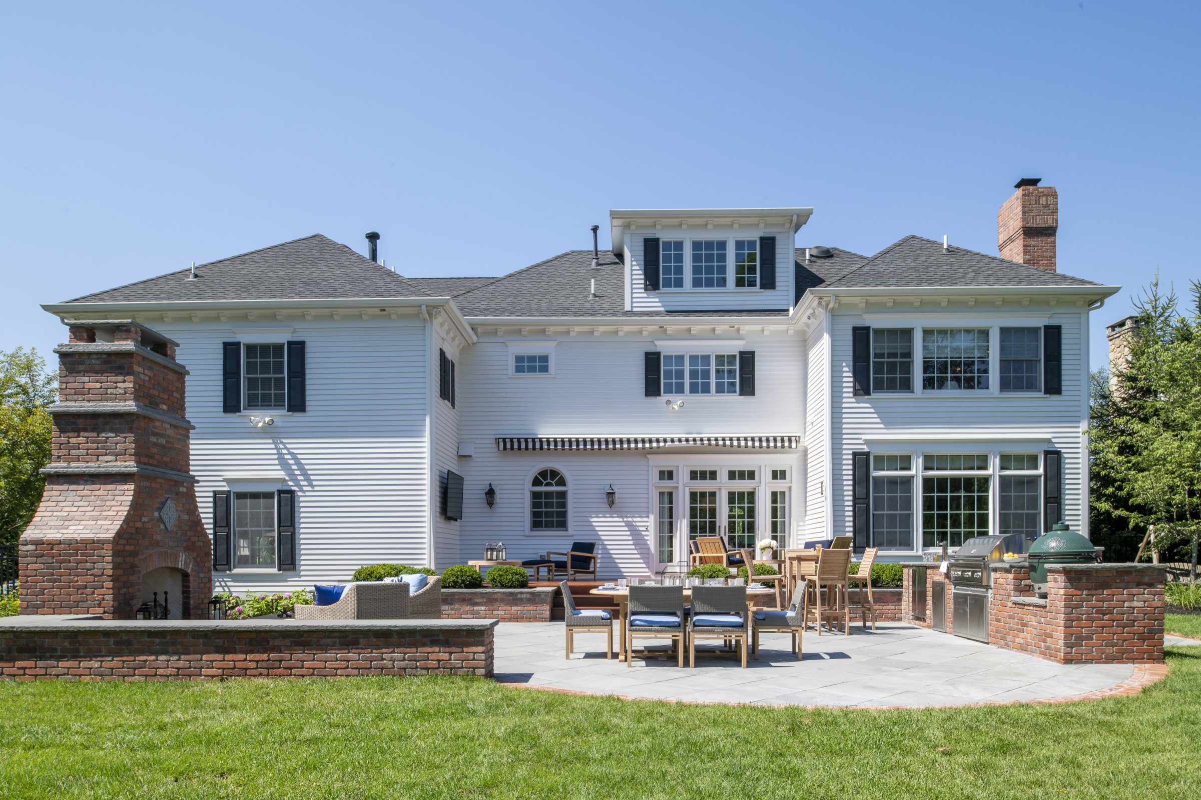 Elegant suburban home with patio and lawn
