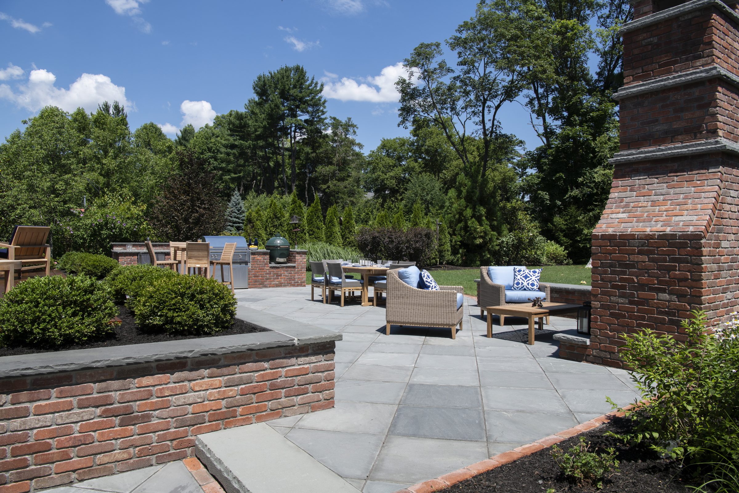 Outdoor patio with seating and greenery