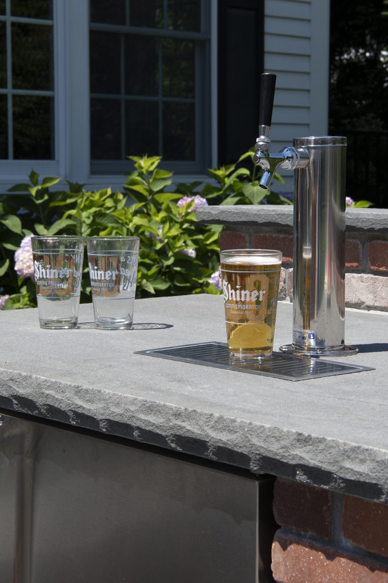 Outdoor beer tap with glasses on counter