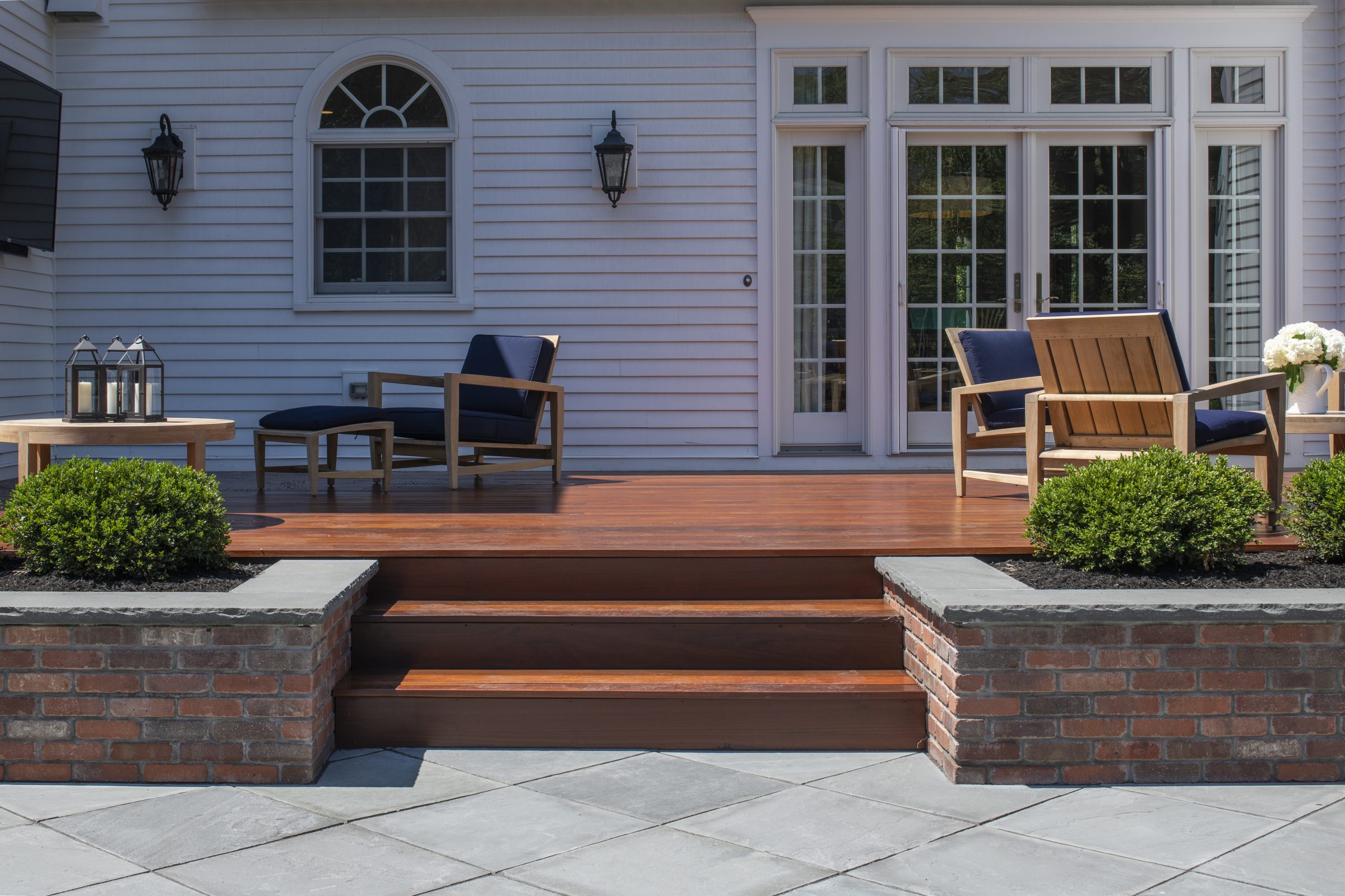 Elegant backyard patio with wooden deck