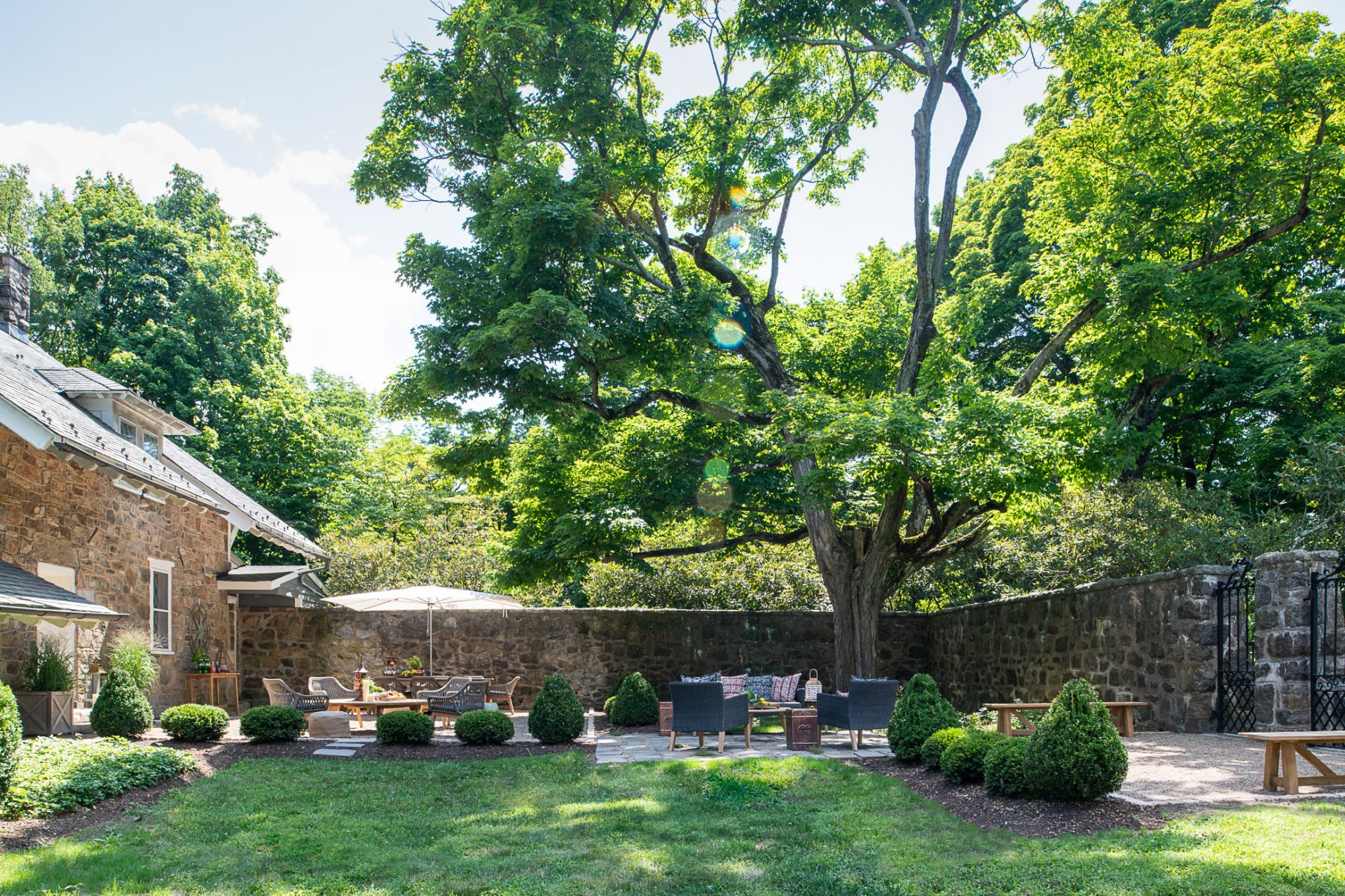 Charming garden with seating area and large tree
