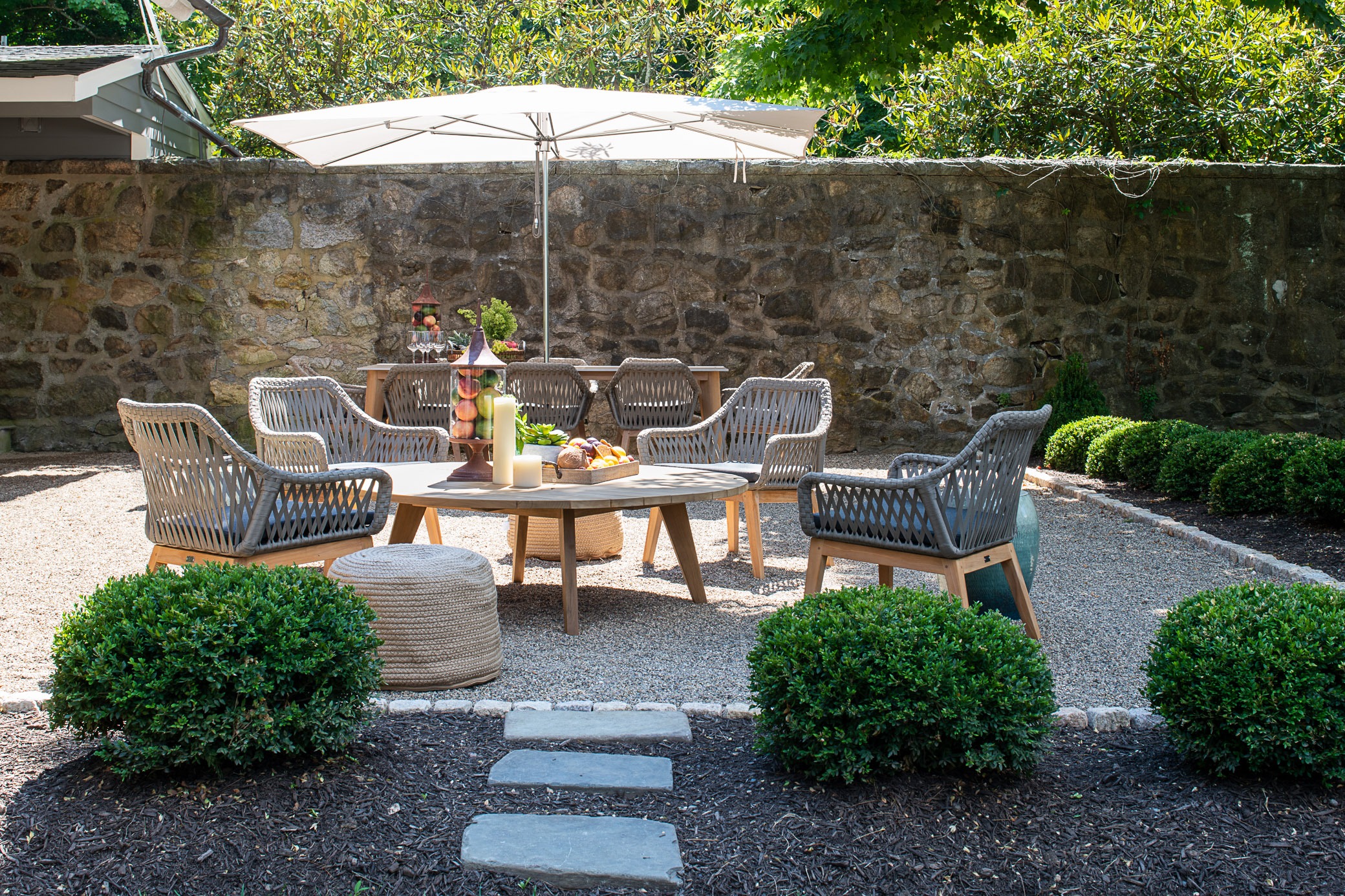 Outdoor patio with chairs and umbrella.