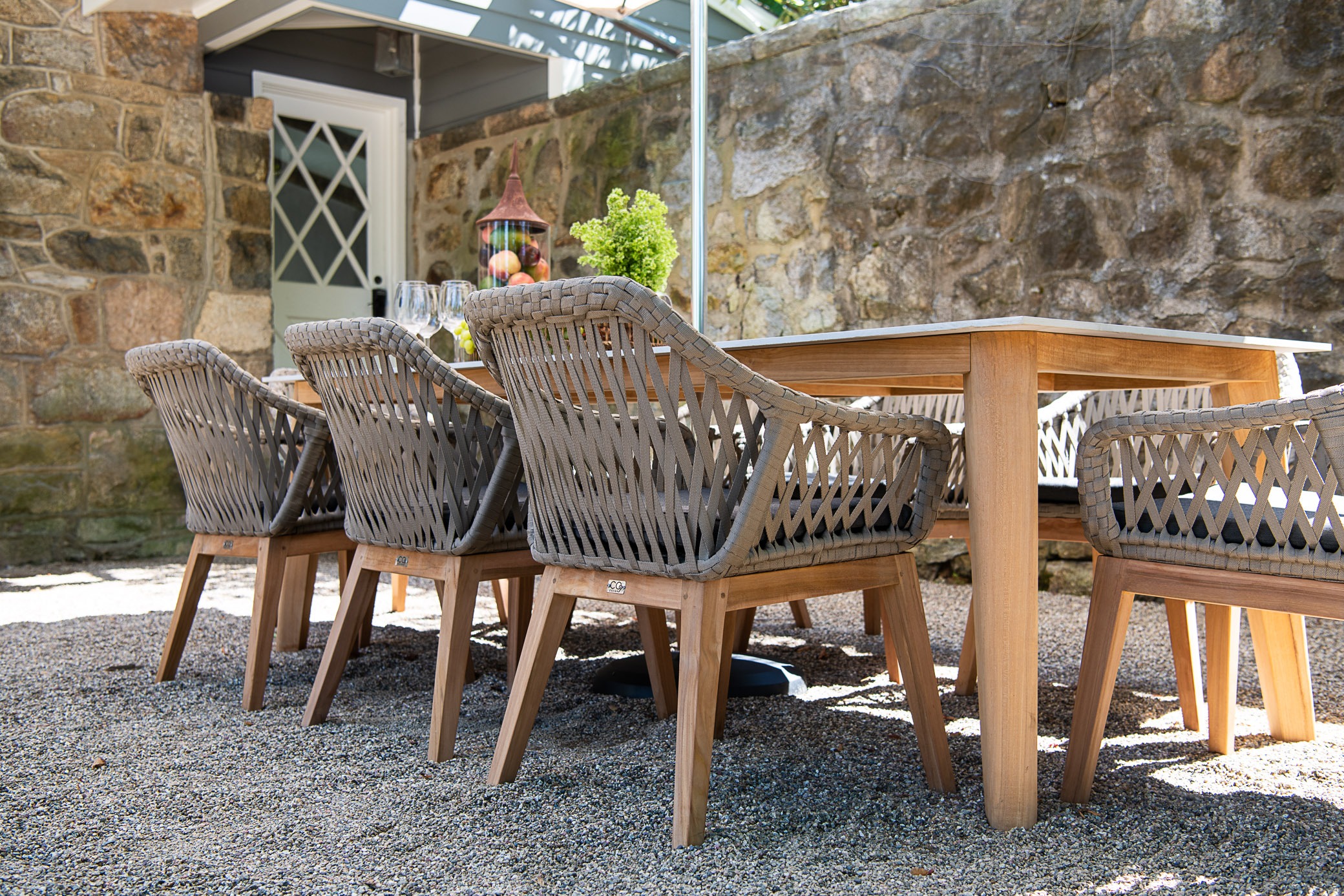 Outdoor dining set on stone patio.