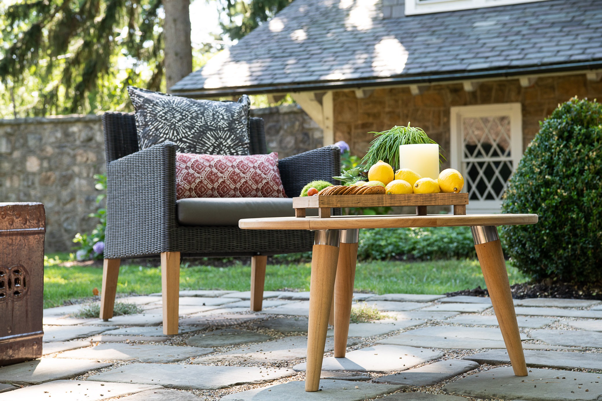 Cozy patio seating with lemons on table.