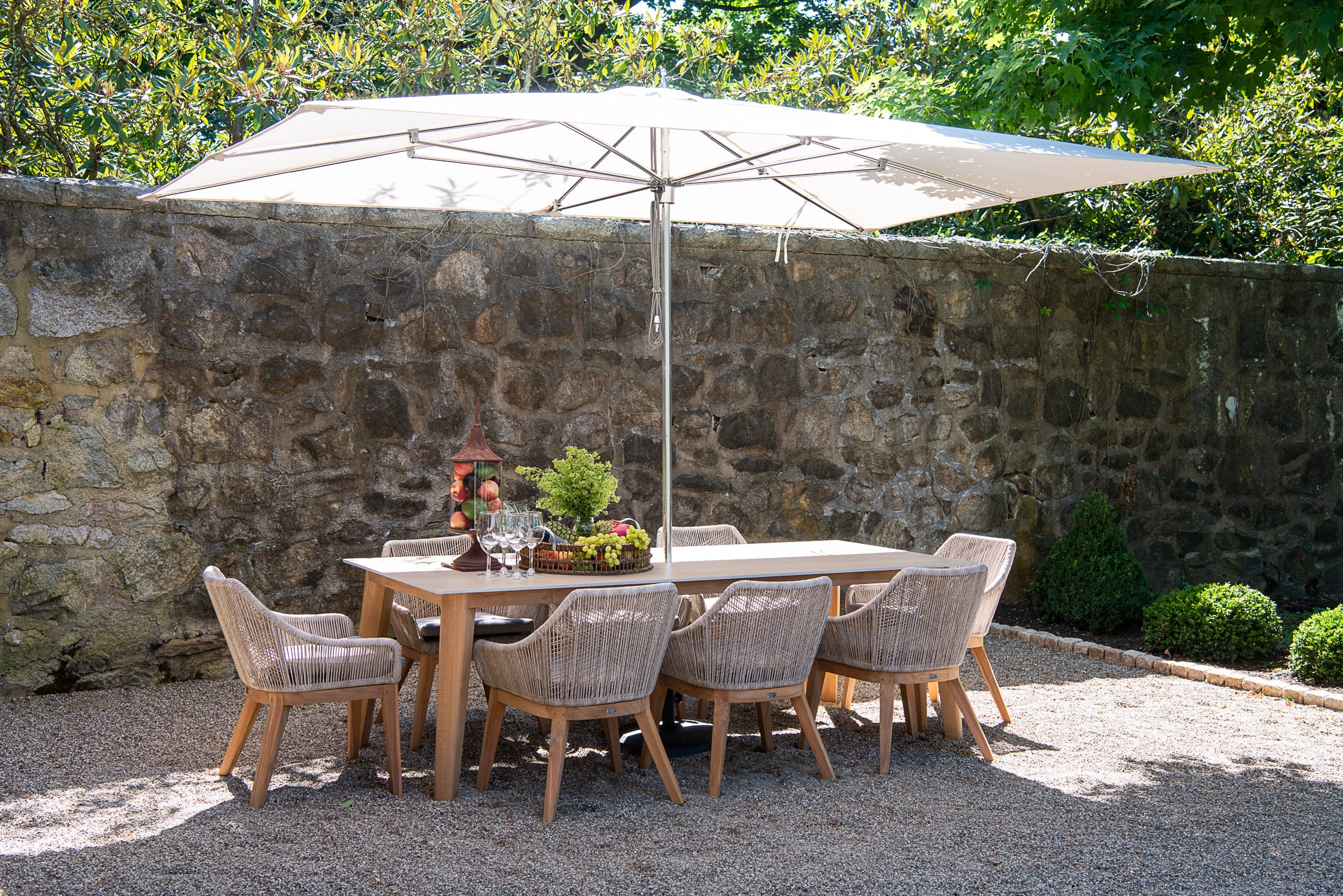 Outdoor dining set under large umbrella.