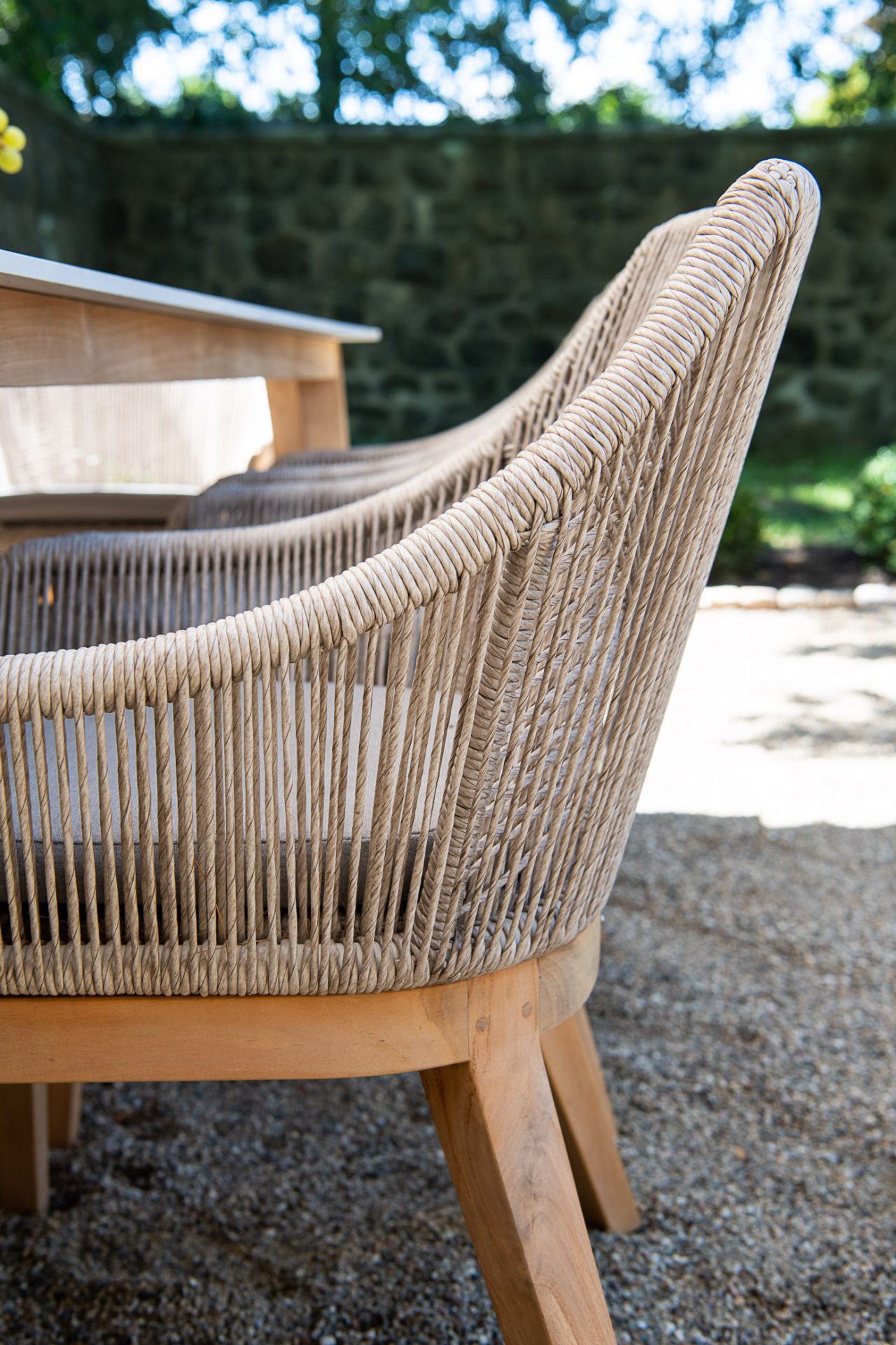 Woven patio chairs and wooden table