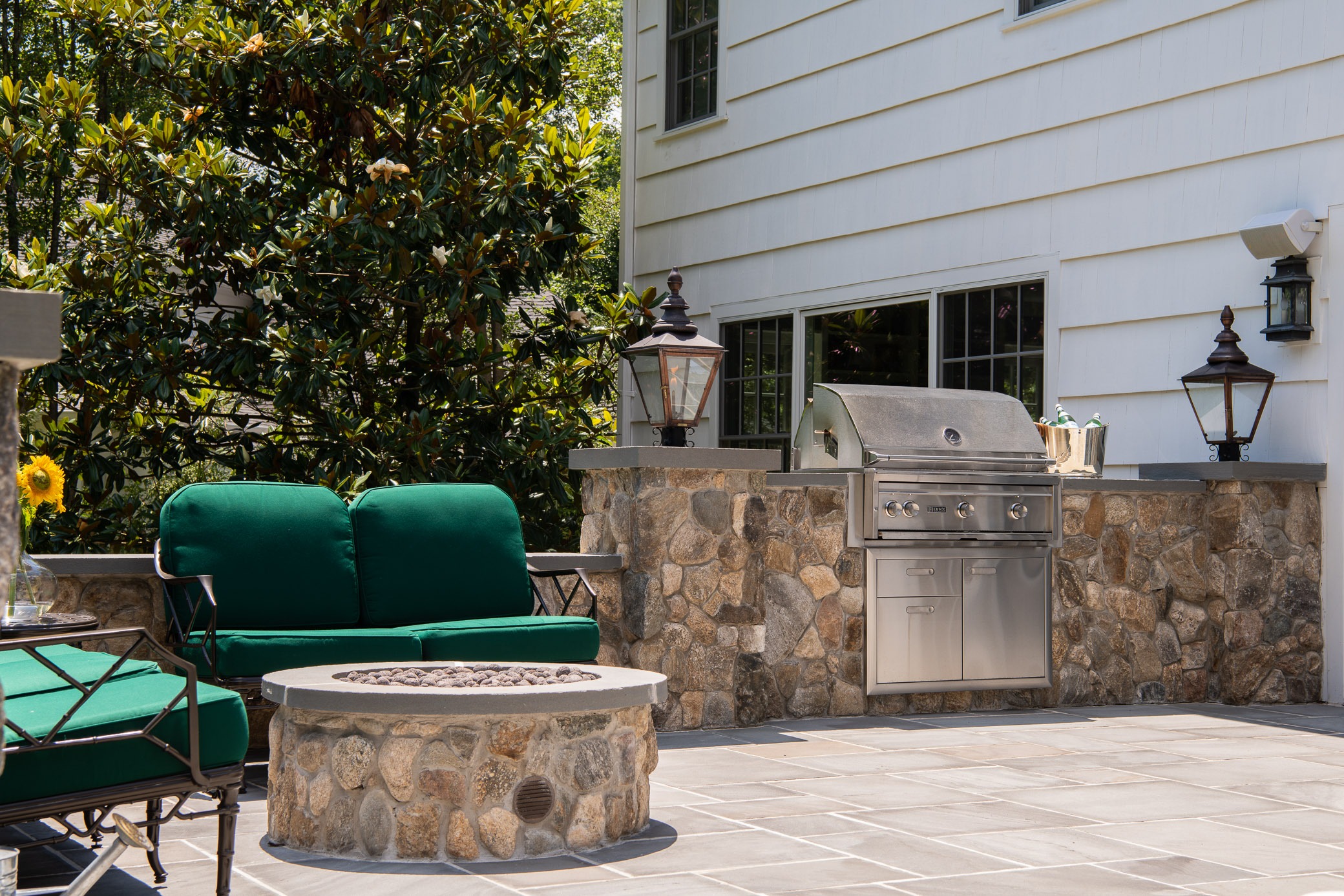 Outdoor patio with grill and seating area