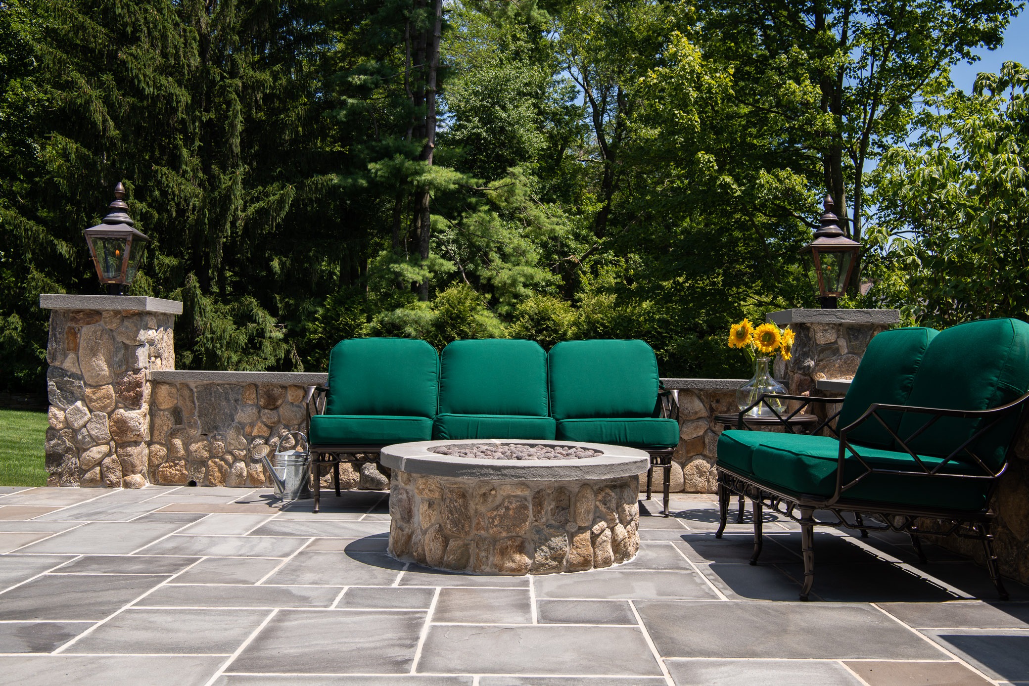 Outdoor patio with green cushioned seating.
