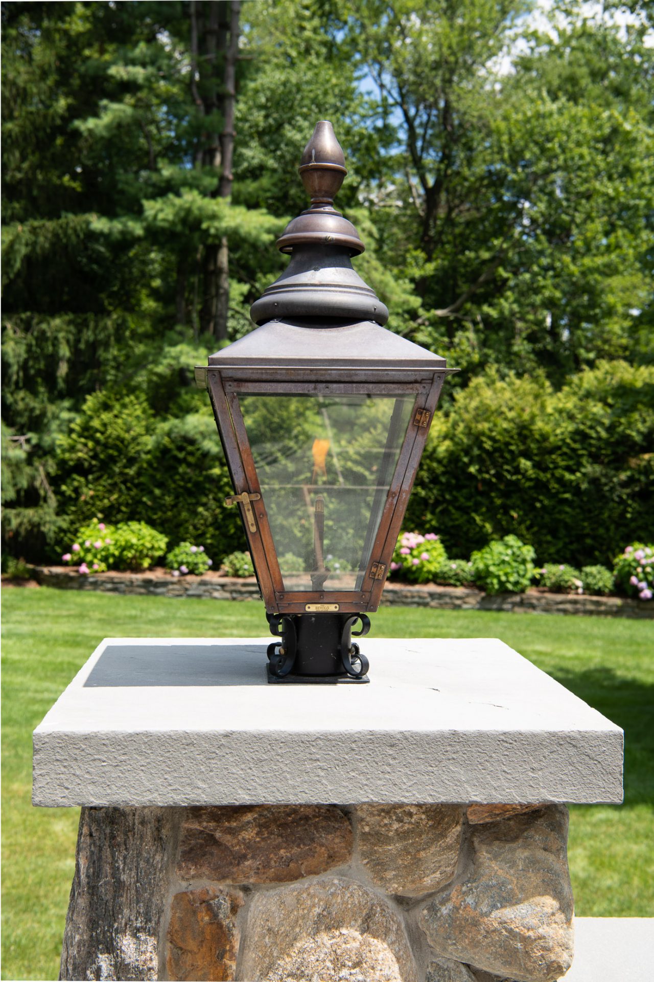 Vintage lantern on stone pillar outdoors