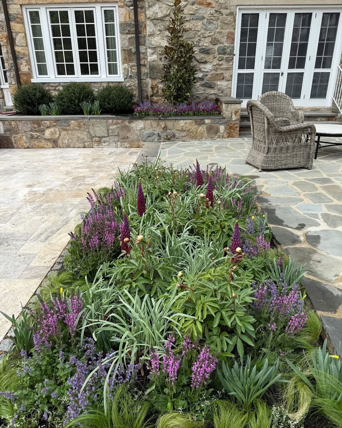 Colorful garden with stone house background
