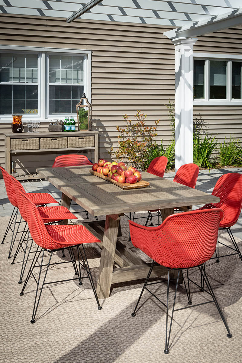 Patio dining set with red chairs.