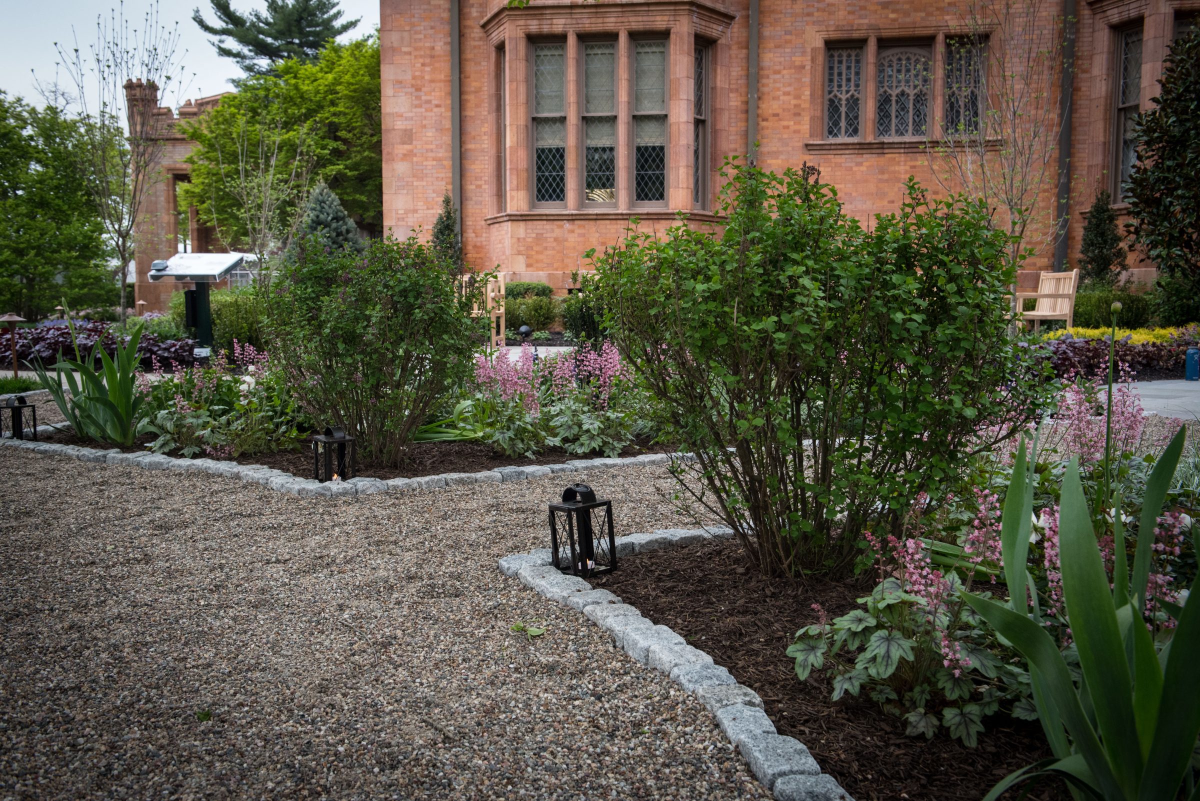 Elegant garden with brick building backdrop