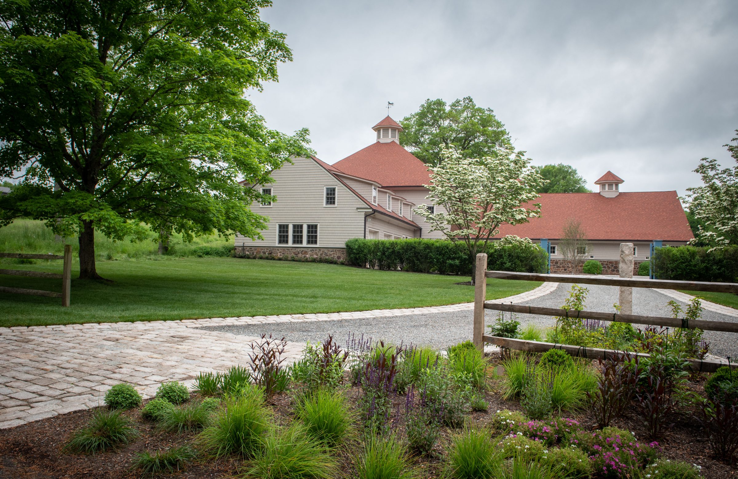 Countryside building with red roof and gardens