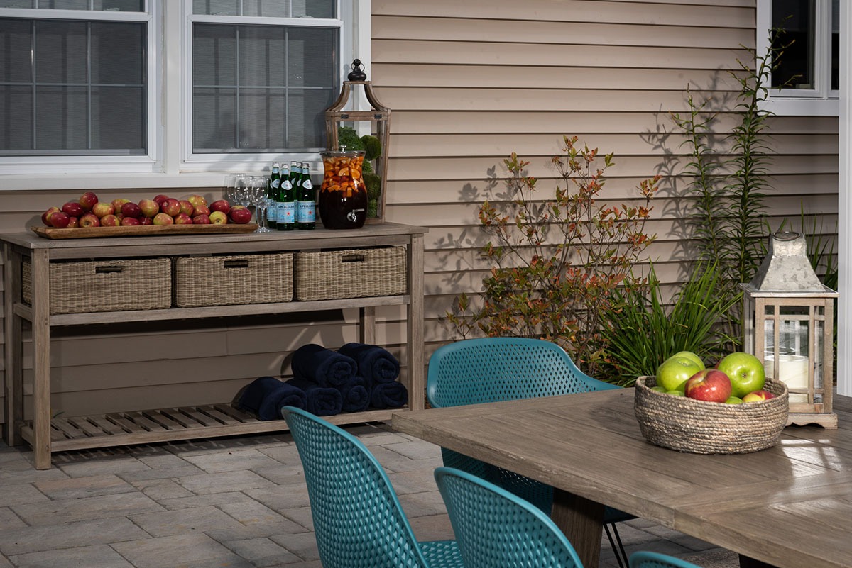 Outdoor patio with apples and drinks setup.
