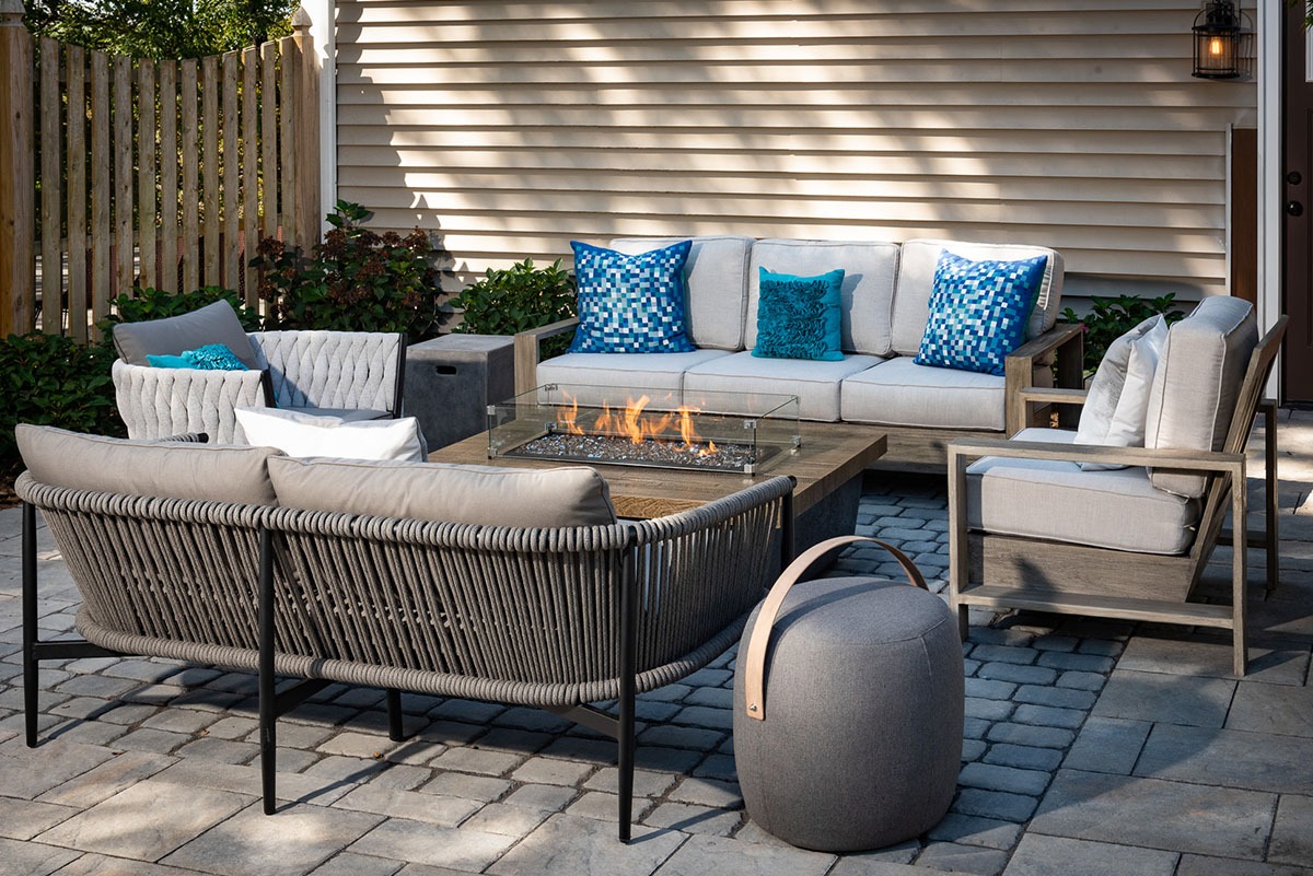 Cozy patio with seating and fire pit.