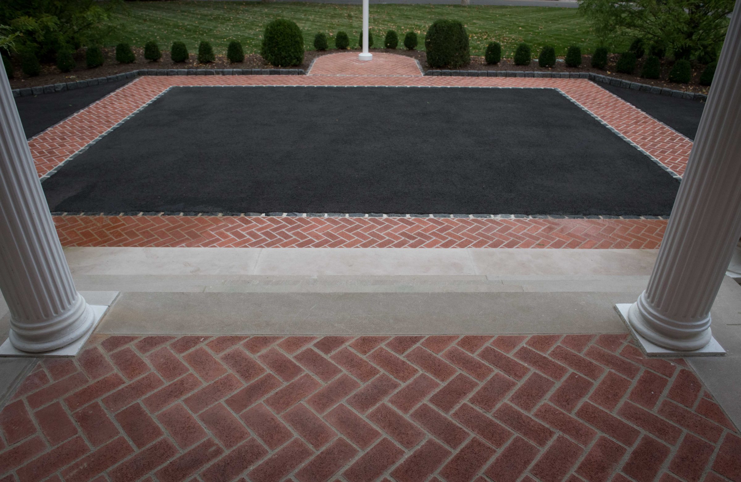 Brick-patterned driveway and steps landscape