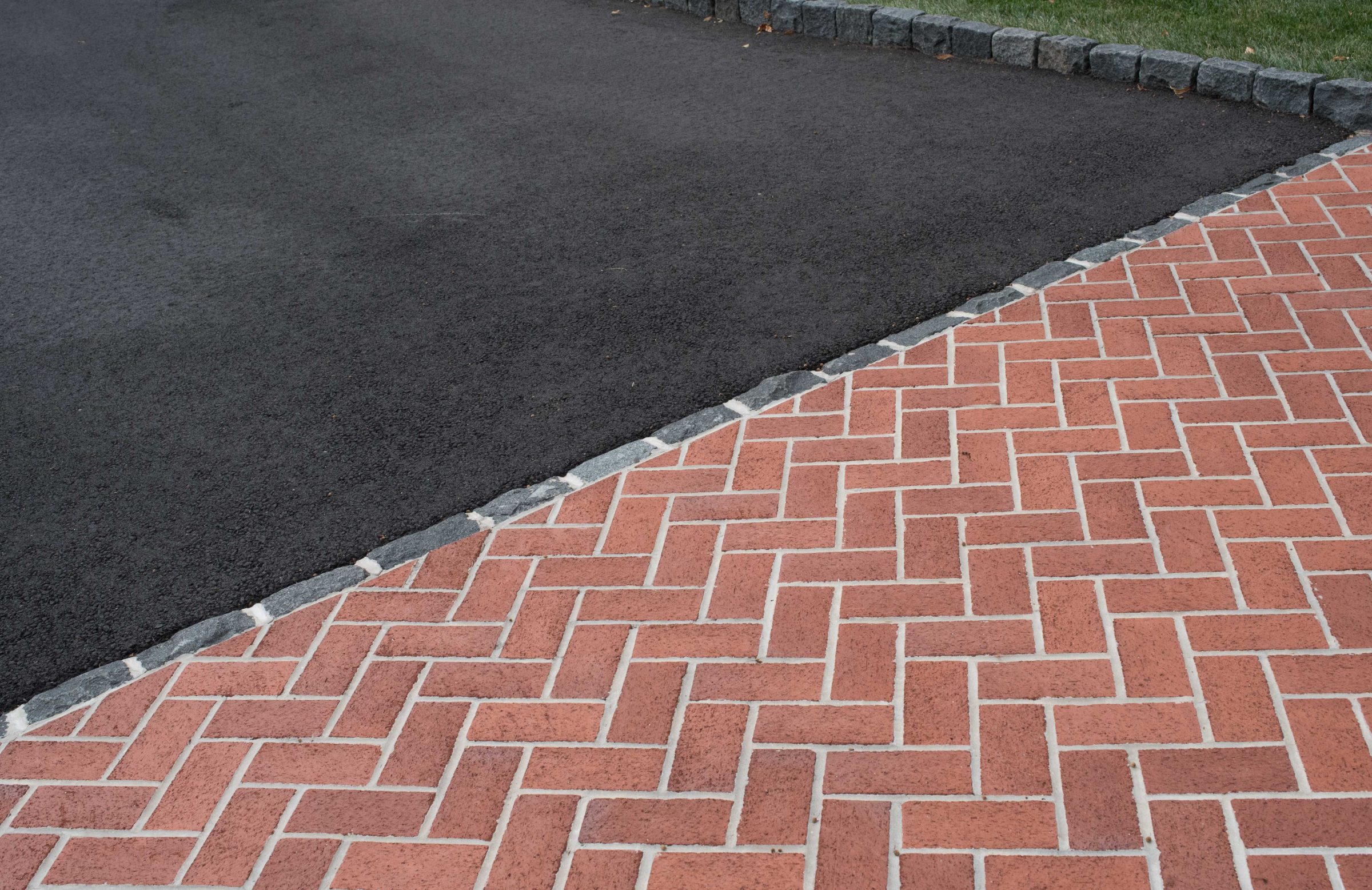 Brick and asphalt driveway intersection