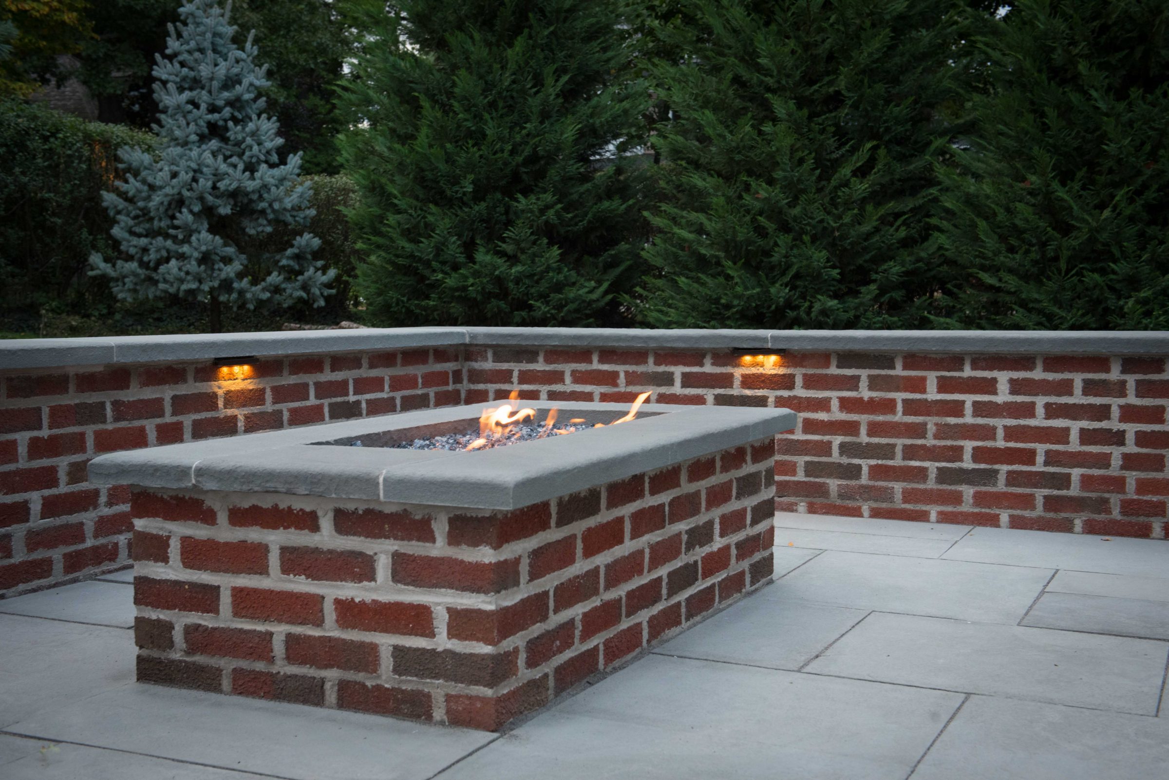 Brick patio with fire pit and trees