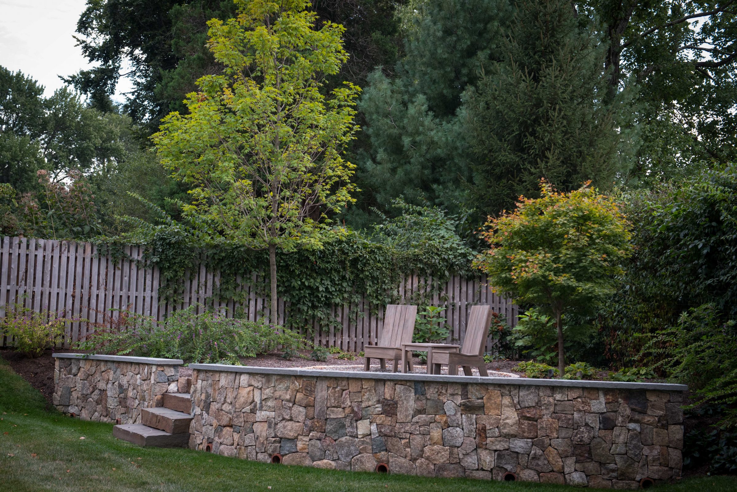 Garden seating area with wooden chairs