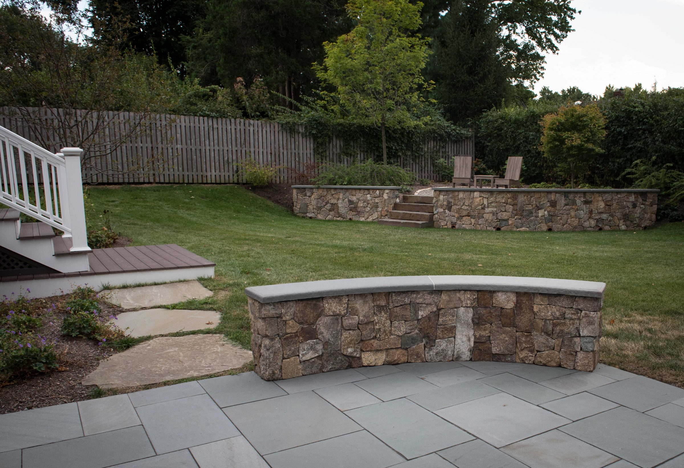 Backyard with stone patio and steps