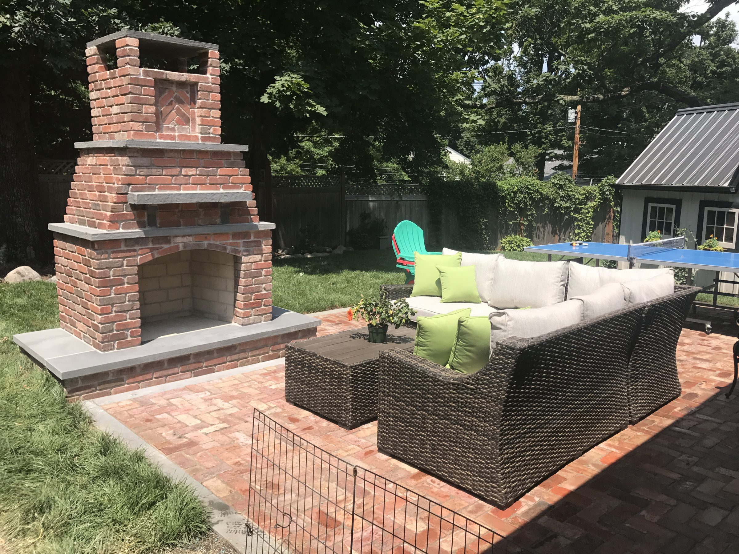 Outdoor patio with brick fireplace.