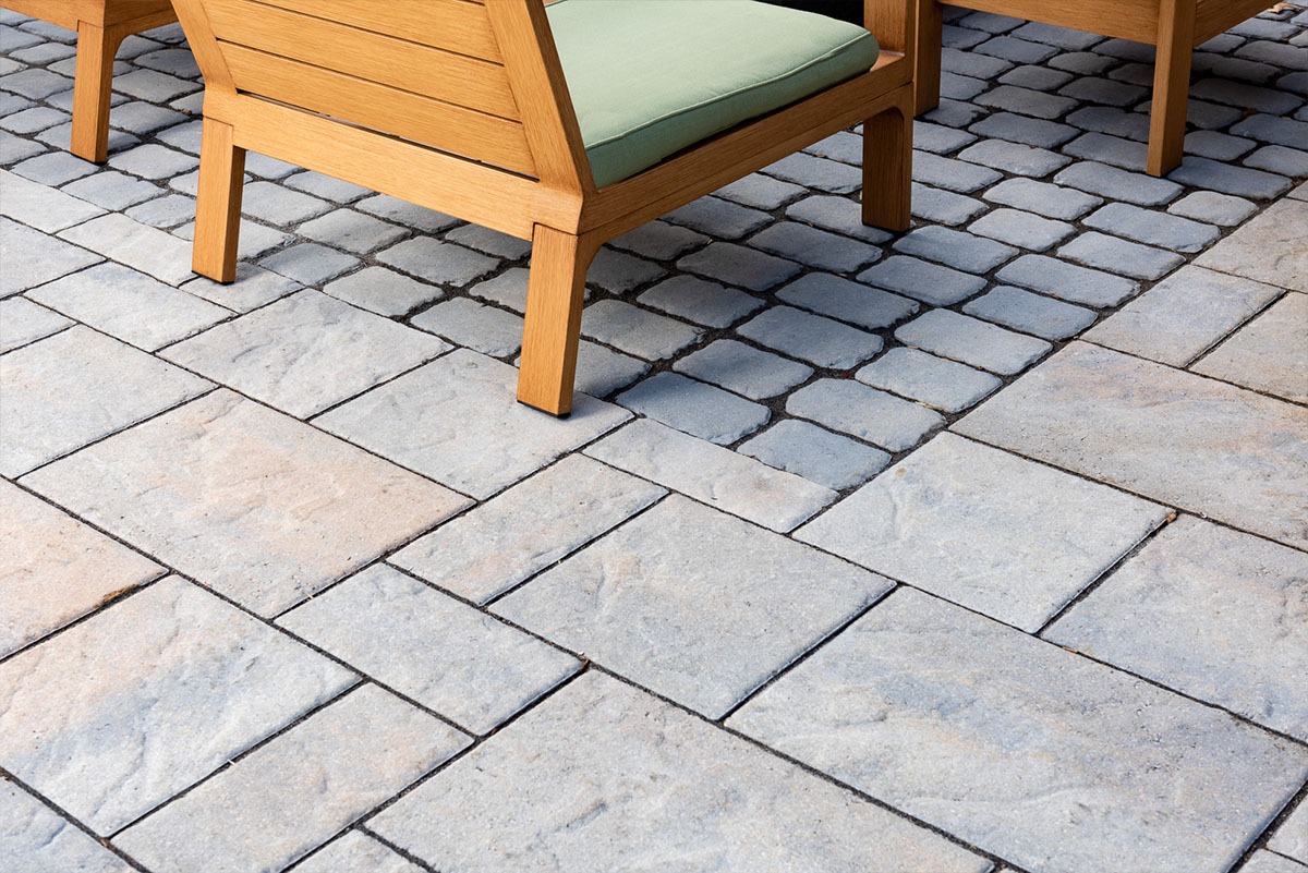 Patio with wooden furniture and stone pavers