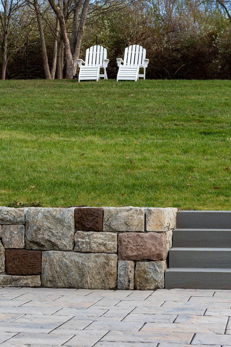 Two chairs on a hillside lawn
