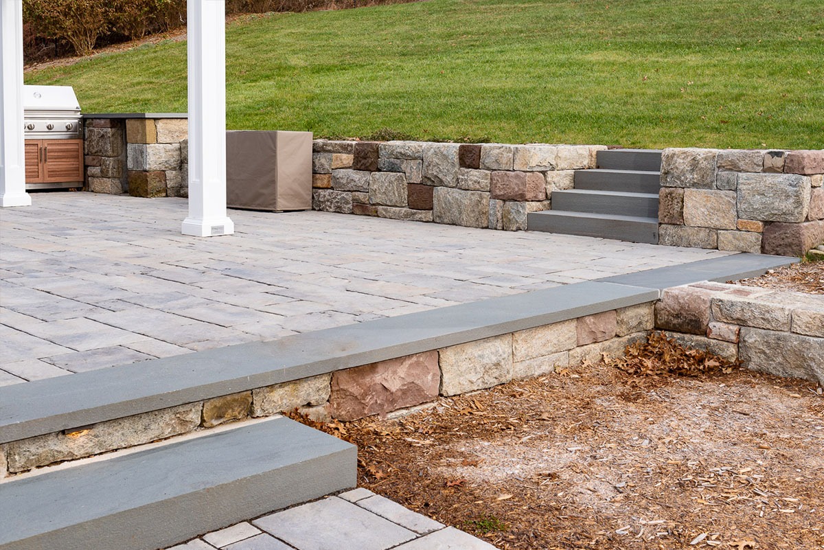 Stone patio with built-in grill.