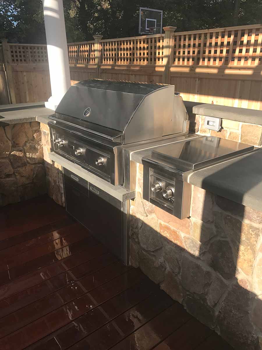 Outdoor stainless steel barbecue grill setup