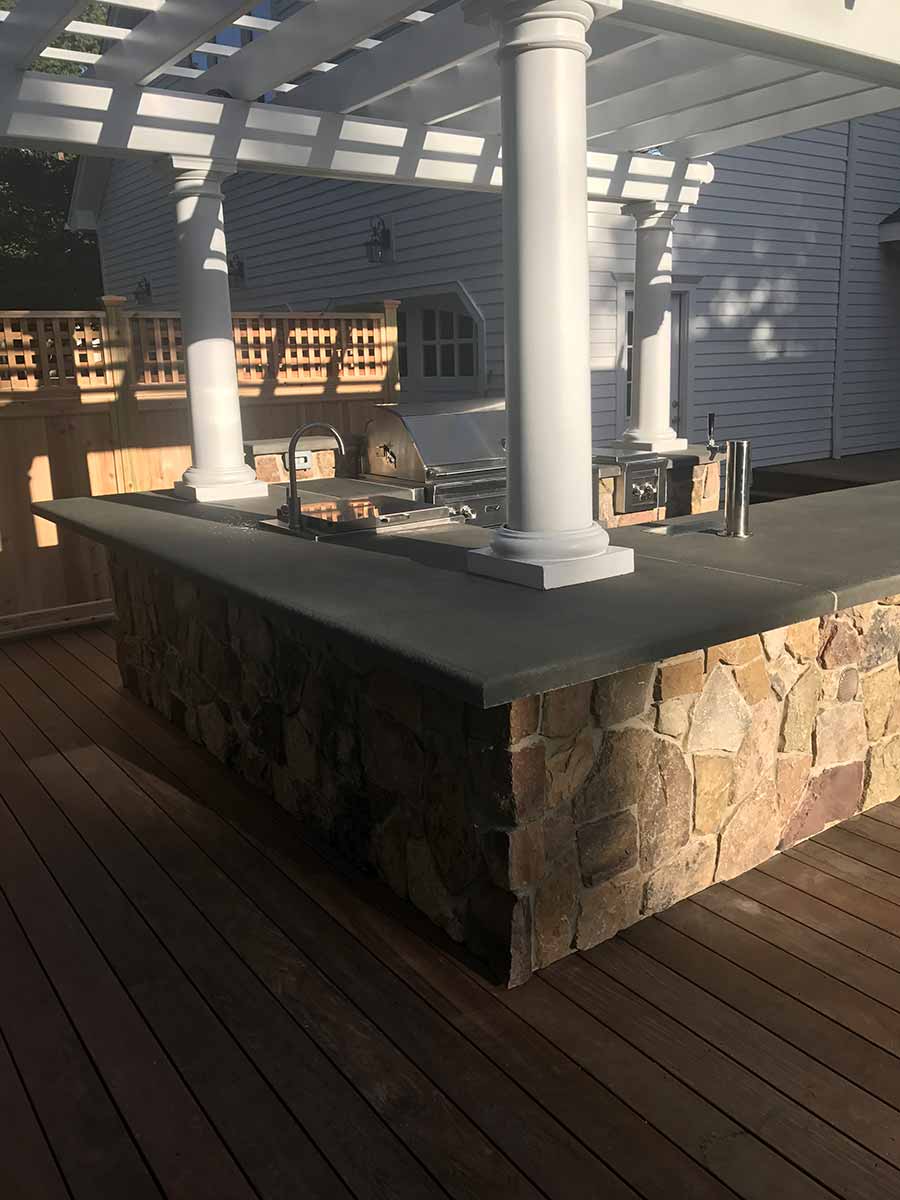 Outdoor kitchen with pergola and grill