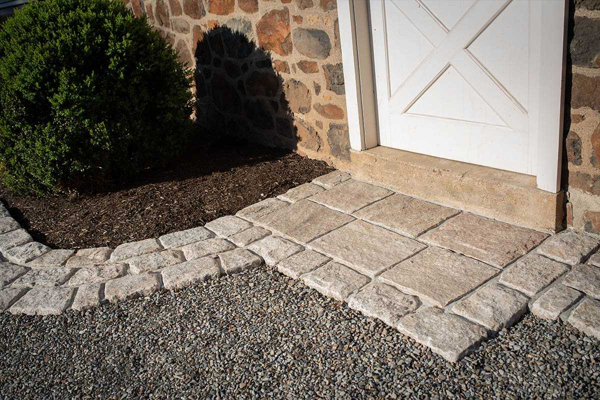 Stone doorway with paving and greenery