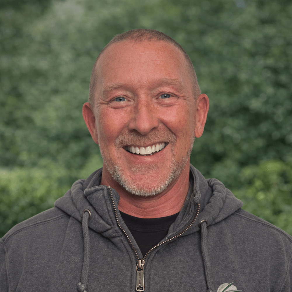 Smiling man in a hoodie outdoors