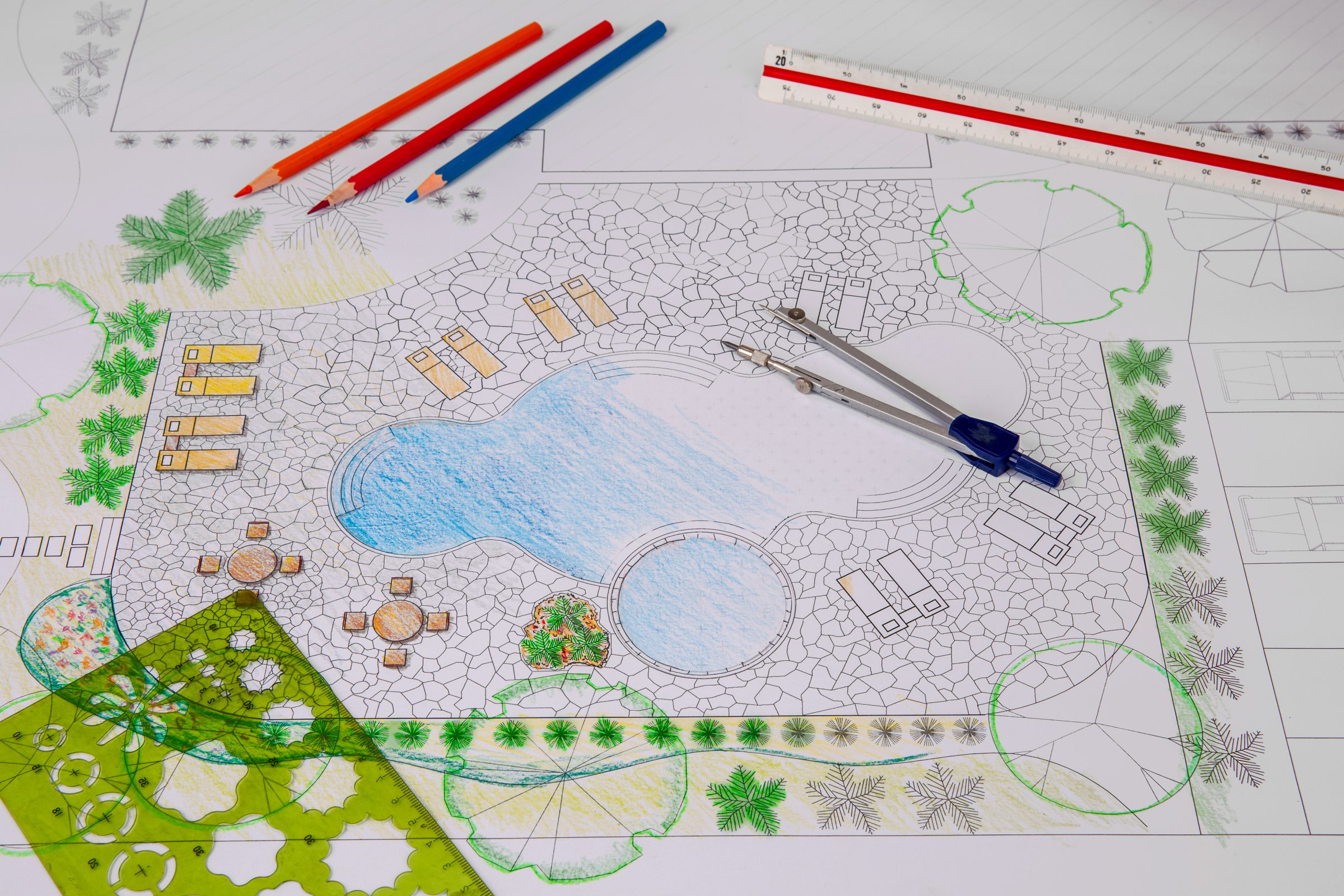 Landscape design blueprint with colorful pencils.