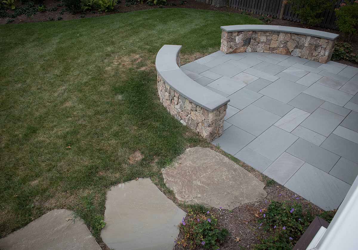 Stone patio with curved seat wall
