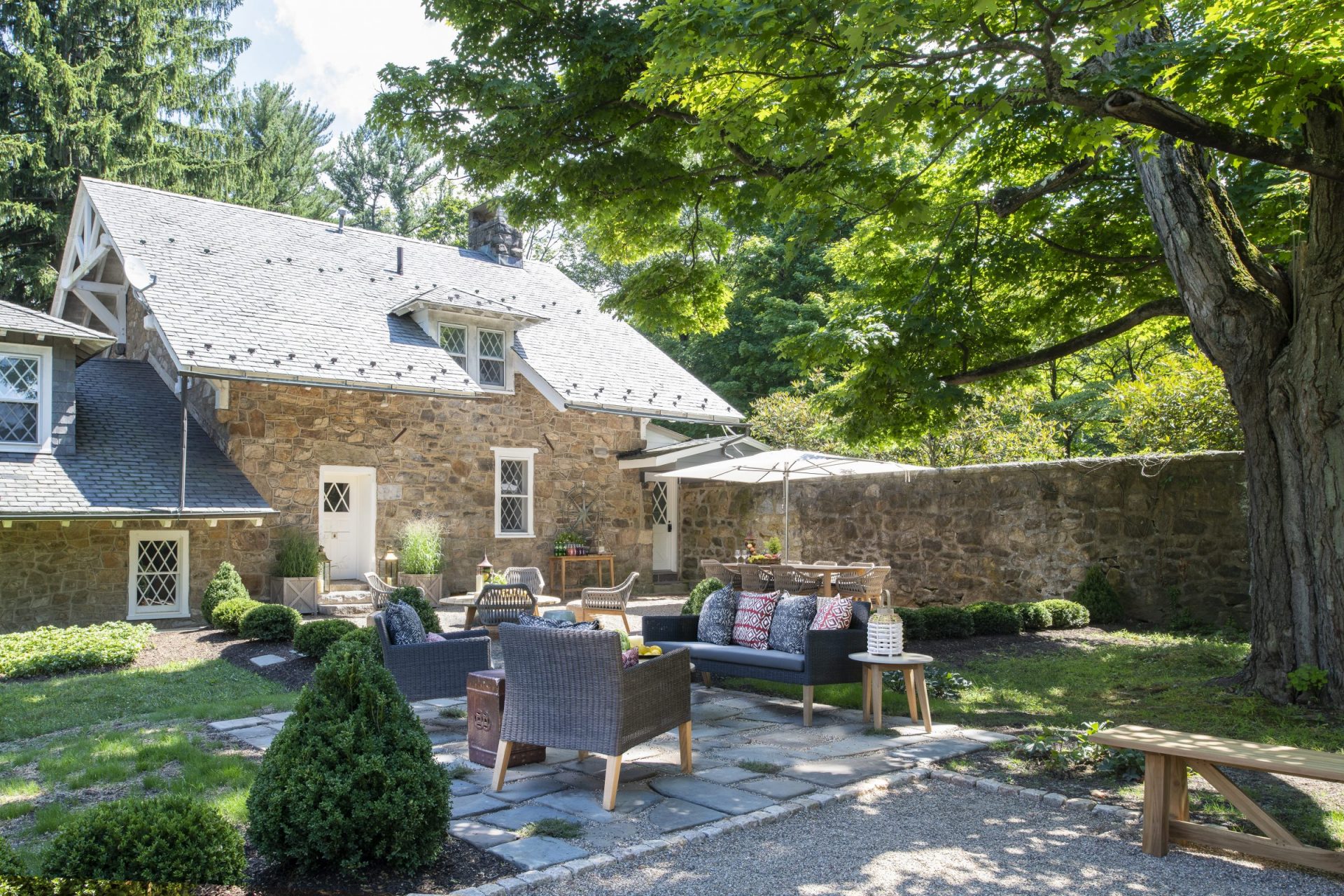 Stone cottage with shaded patio and garden seating